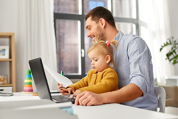 Image showing working father with baby daughter at home office