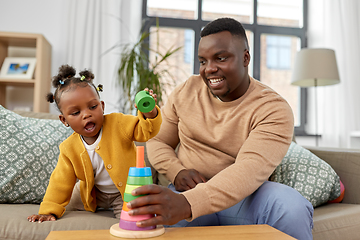 Image showing african family playing with baby daughter at home