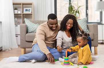 Image showing african family playing with baby daughter at home