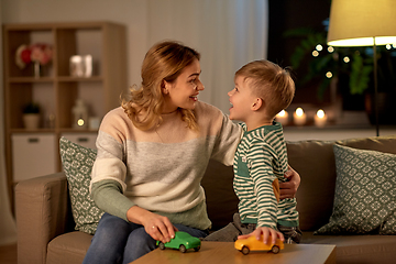 Image showing mother and son playing with toy cars at home