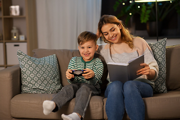 Image showing happy mother with little son spending time at home