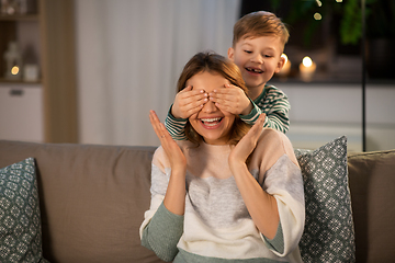 Image showing happy smiling mother playing with her son at home