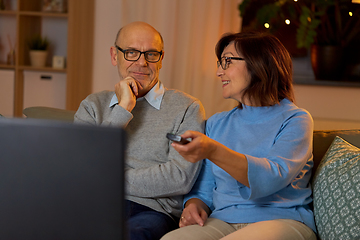 Image showing senior couple watching tv at home in evening