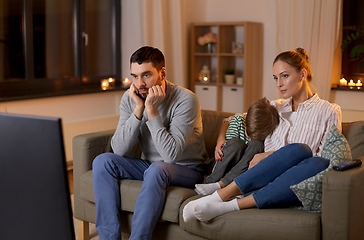 Image showing family watching something boring on tv at night