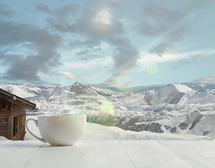 Image showing Single tea or coffee mug and landscape of mountains on background