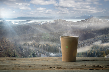 Image showing Single tea or coffee mug and landscape of mountains on background