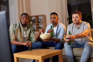 Image showing male friends with beer watching tv at home