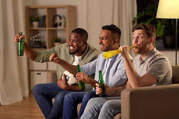 Image showing friends or soccer fans with ball and beer at home