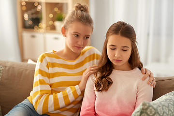 Image showing teenage girl comforting her sad friend at home