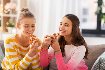 Image showing happy teenage girls eating pizza at home