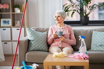 Image showing senior woman drinking coffee after home cleaning