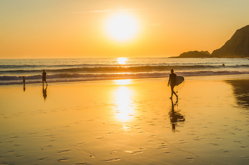 Image showing Surfing at sunset, Algarve, Portugal