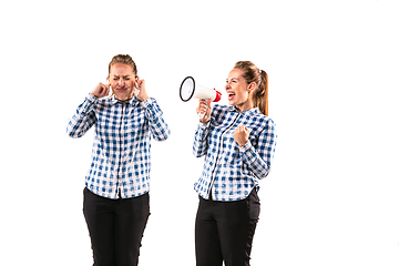 Image showing Young handsome woman arguing with herself on white studio background.