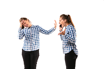 Image showing Young handsome woman arguing with herself on white studio background.