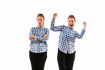 Image showing Young handsome woman arguing with herself on white studio background.