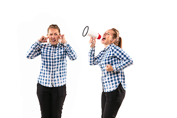 Image showing Young handsome woman arguing with herself on white studio background.