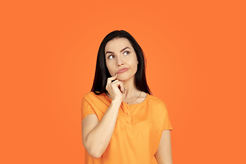 Image showing Caucasian young woman\'s portrait on orange background