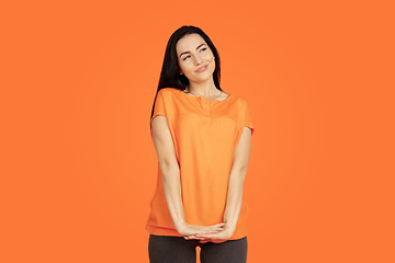 Image showing Caucasian young woman\'s portrait on orange background