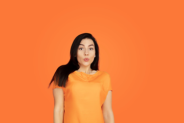 Image showing Caucasian young woman\'s portrait on orange background