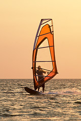 Image showing Windsurfer on waves of a gulf on a sunset