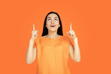 Image showing Caucasian young woman\'s portrait on orange background