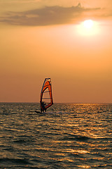 Image showing Silhouette of a windsurfer on a gulf on a sunset