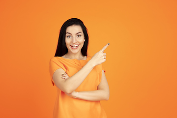 Image showing Caucasian young woman\'s portrait on orange background