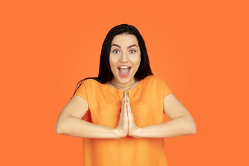 Image showing Caucasian young woman\'s portrait on orange background