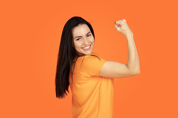 Image showing Caucasian young woman\'s portrait on orange background