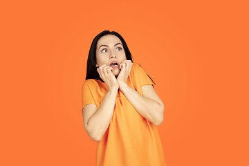 Image showing Caucasian young woman\'s portrait on orange background