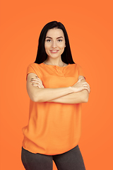 Image showing Caucasian young woman\'s portrait on orange background