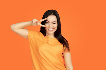 Image showing Caucasian young woman\'s portrait on orange background