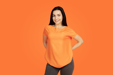 Image showing Caucasian young woman\'s portrait on orange background