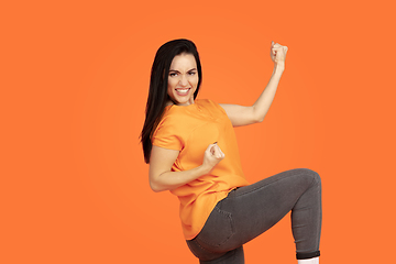 Image showing Caucasian young woman\'s portrait on orange background