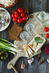 Image showing Vodka and traditional snack on wooden background