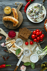 Image showing Vodka and traditional snack on wooden background