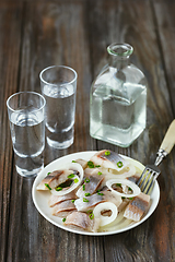 Image showing Vodka and traditional snack on wooden background