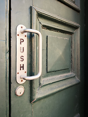 Image showing Old door with door handle and the inscription push