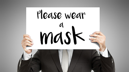 Image showing business man message Please wear a mask