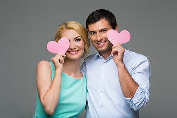 Image showing Beautiful couple holding pink hearts