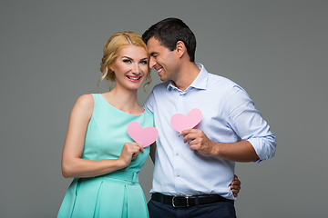 Image showing Beautiful couple holding pink hearts