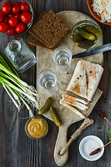 Image showing Vodka and traditional snack on wooden background