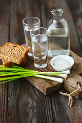 Image showing Vodka and traditional snack on wooden background