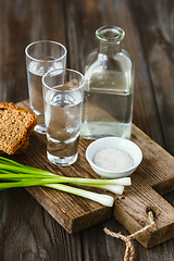 Image showing Vodka and traditional snack on wooden background