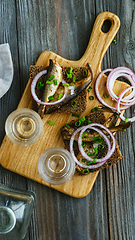 Image showing Vodka and traditional snack on wooden background