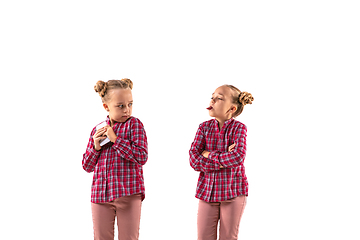 Image showing Young handsome girl arguing with herself on white studio background.