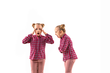 Image showing Young handsome girl arguing with herself on white studio background.