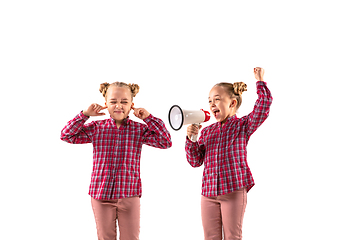 Image showing Young handsome girl arguing with herself on white studio background.