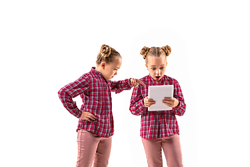 Image showing Young handsome girl arguing with herself on white studio background.