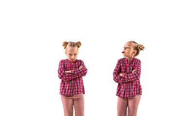 Image showing Young handsome girl arguing with herself on white studio background.